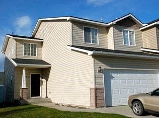 Rathdrum apartment for rent - a white house with a car parked in the driveway