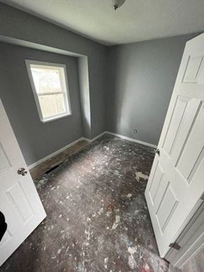 Akron apartment for rent - A room with a white door and a window with a grey wall.