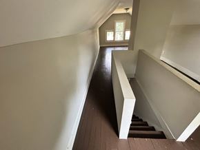 Akron house for rent - A staircase with a white railing and wooden steps.