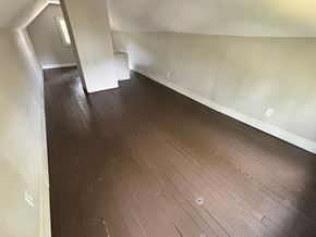 Akron house for rent - A room with wooden flooring and white walls.