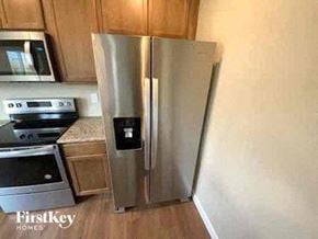 Colorado Springs house for rent - a stainless steel refrigerator in a kitchen next to a stove