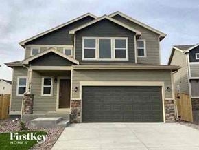 Colorado Springs house for rent - a brown house with a garage door
