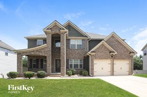 Conyers house for rent - a large brick house with two garage doors