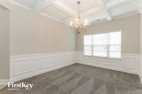Conyers house for rent - a dining room with a chandelier and a window