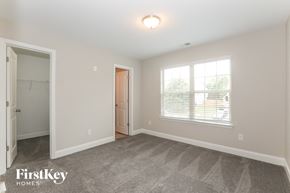 Conyers house for rent - a master bedroom with carpeted flooring and a large window