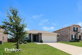 Aubrey house for rent - A house with a garage and a tree in front of it.