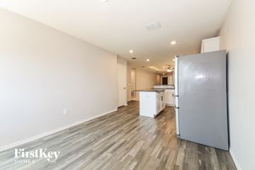Aubrey house for rent - A kitchen with a refrigerator and a dining table.