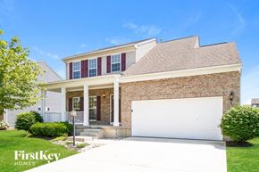 Batavia house for rent - a brick house with a white garage door