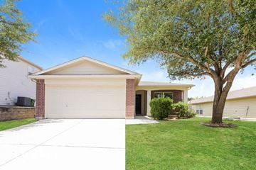 Schertz house for rent - a house with a tree in the yard and a white driveway