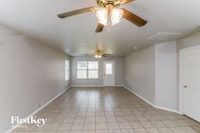 Schertz house for rent - an empty living room with a ceiling fan