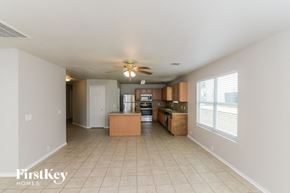 Schertz house for rent - a kitchen and living room with a ceiling fan