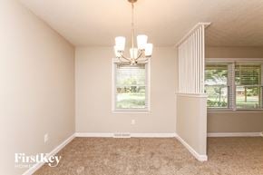 Concord house for rent - an empty living room with a window and a chandelier