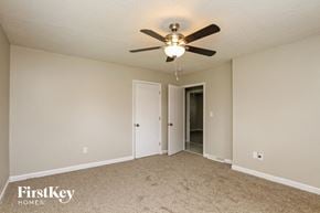 Concord house for rent - a bedroom with a ceiling fan and a door to a closet