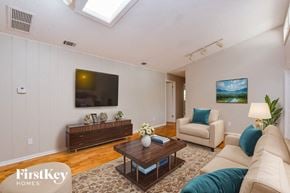Longwood house for rent - A living room with a skylight, a flat screen TV, a coffee table, and a couch.