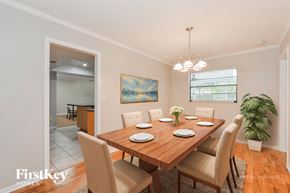 Longwood house for rent - A dining room with a wooden table set for six.