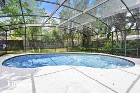 Longwood house for rent - A pool enclosed by a glass wall.