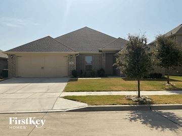 Aledo house for rent - a house with a driveway and a garage door