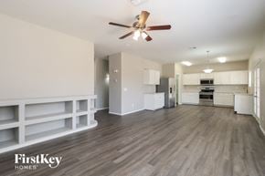 San Tan Valley house for rent - A spacious room with a ceiling fan and wooden flooring.