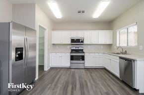 San Tan Valley house for rent - A kitchen with a refrigerator, oven, and sink.