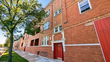 Chicago apartment for rent - A red brick building with a tree in front of it.