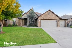 Mustang house for rent - a house with a garage and a lawn