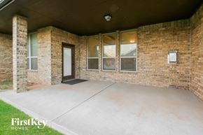 Mustang house for rent - an empty porch in a brick building with a door