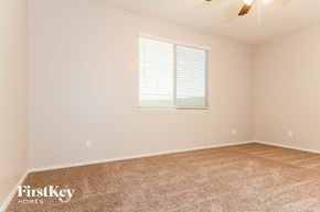 Surprise house for rent - the spacious living room with carpeting and a window