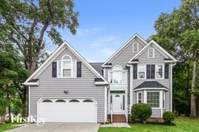 Greensboro house for rent - a gray house with a white garage door