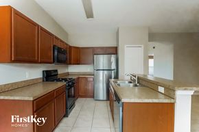 Davenport house for rent - a kitchen with wooden cabinets and stainless steel appliances