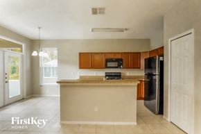 Davenport house for rent - a kitchen with an island and a black refrigerator