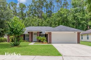 Jacksonville house for rent - A house with a garage and a driveway in front of it.
