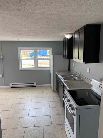 Barberton apartment for rent - a kitchen with a stove and a sink and a window
