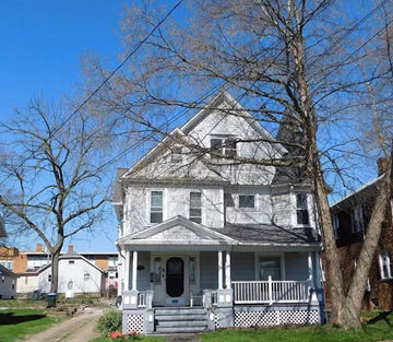 Cuyahoga Falls apartment for rent - a white house with a white porch and a tree