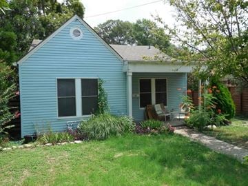 Austin apartment for rent - A small blue house with a white window and a white door.