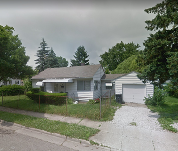 Akron house for rent - A house with a grey roof and a white garage door.