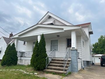 Cleveland apartment for rent - A white house with a red roof and a porch.