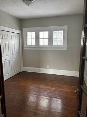 Akron apartment for rent - A room with a white door and a window with white shutters.