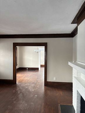 Akron apartment for rent - A room with a fireplace and wood flooring.