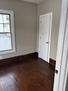 Akron apartment for rent - A room with a white door and a window with snow outside.