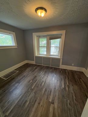 Akron house for rent - A room with a window and wooden flooring.