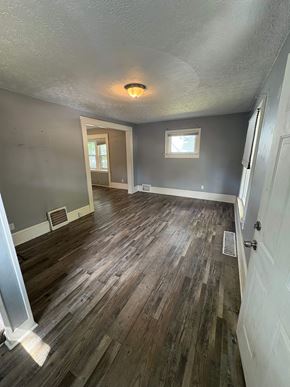 Akron house for rent - A room with wooden floors and a window.