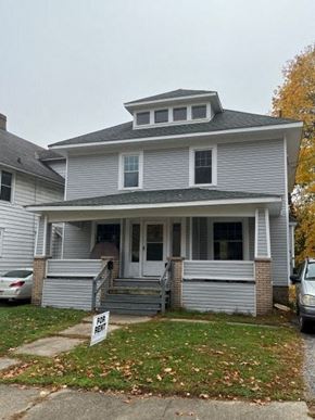 Akron apartment for rent - A house with a "For Rent" sign in front.