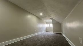 Akron apartment for rent - A long, empty hallway with carpeted floors and white walls.