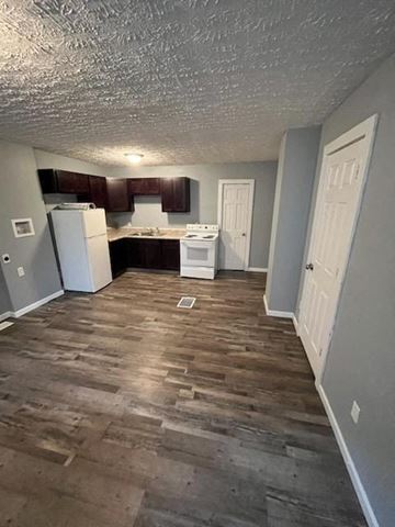 Akron apartment for rent - A kitchen with wooden floors and white appliances.