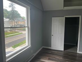 Akron apartment for rent - a living room with a large window and a white door