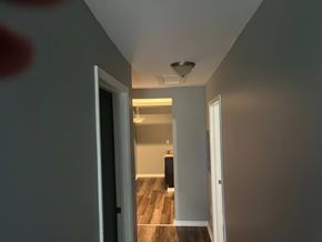 Akron apartment for rent - a hallway with a door to a room and a ceiling fan