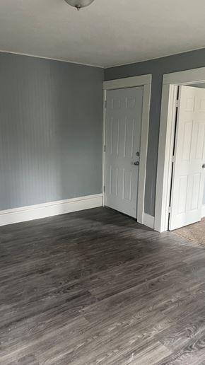 Akron apartment for rent - a living room with grey walls and a white door