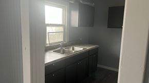 Akron apartment for rent - an empty kitchen with a sink and a window