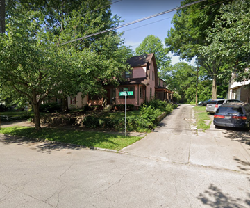 Akron house for rent - a street with cars parked in front of a house