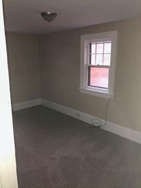 Akron house for rent - an empty room with a window and a lamp